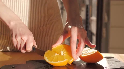 Cutting ripe oranges on board close-up. Orange citrus fruits, making fresh juice Stock Footage 172265588