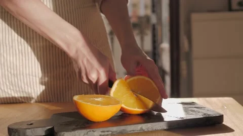 Cutting ripe oranges on board close-up. Orange citrus fruits, making fresh juice Stock Footage 172556663