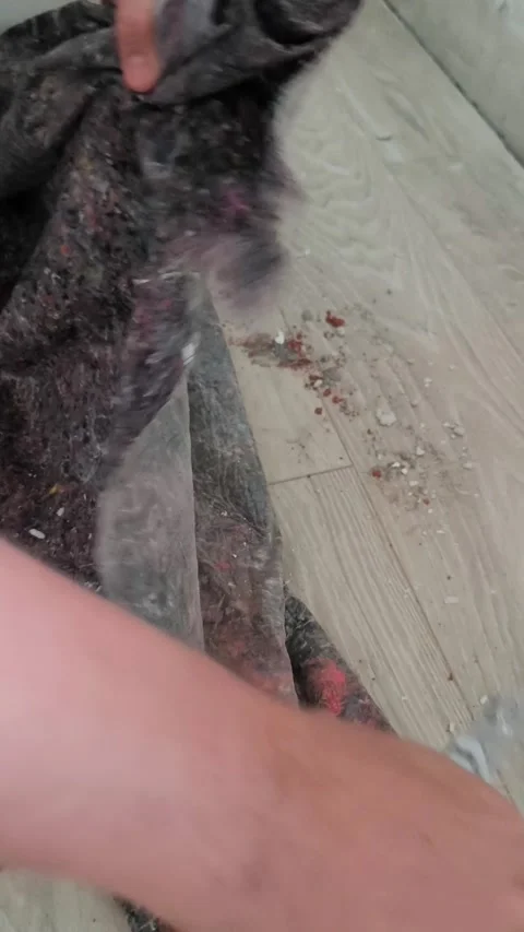 Cutting a roll of colored underlay for laminate flooring with a construction Stock Footage 322549802