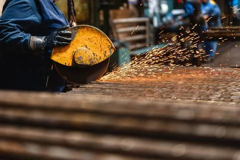 Cutting rolled metal using a powerful abrasive wheel cutting machine Stock Photos