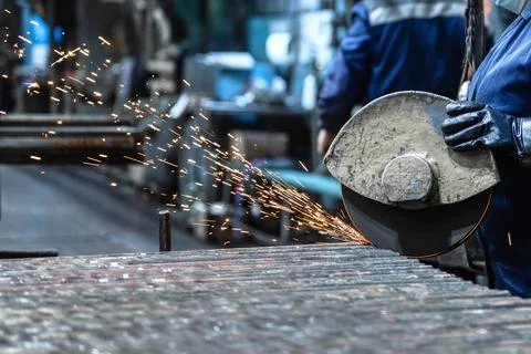 Cutting rolled metal using a powerful abrasive wheel cutting machine Stock Photos