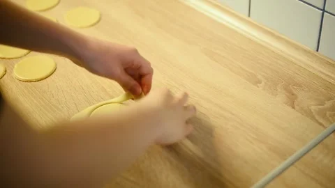 Cutting round cookie dough shapes using a glass cup close up Stock Footage 342704129