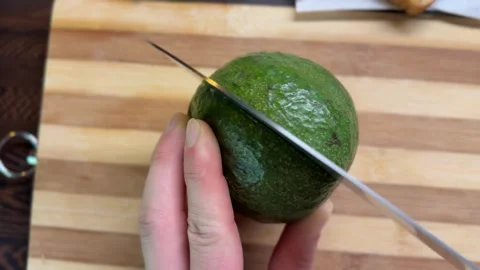 Cutting Round Green Avocado and Removing Pit Stock-Footage 314565425