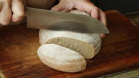 Cutting a rustic country bread Stock Footage 340331065