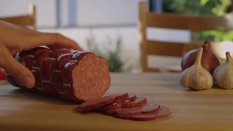 Cutting Salami slices on the table Stock Footage 73287266