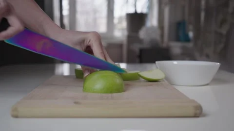 Cutting Second Half Of Green Apple Into Slices On Wooden Cutting Board Stock Footage 330245143