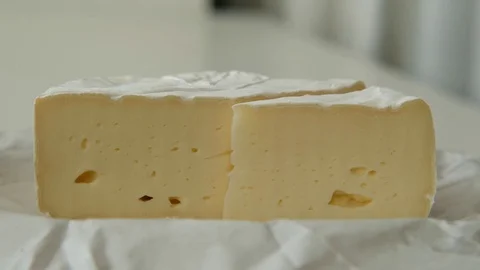 Cutting sectors of soft cheese brie or camembert, close up Stock Footage 127484500