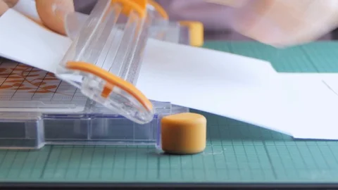 Cutting a sheet of paper with the paper trimmer Video stock 123355575