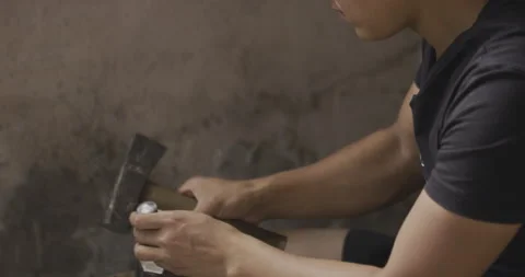 Cutting Silver with hammer force Stock Footage 141356346