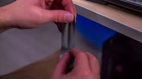 Cutting a silver tape with a razorblade Video stock 58346679
