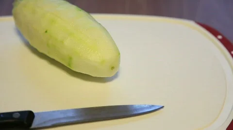 Cutting a Skinned Cucumber on Plate Stock Footage 533561