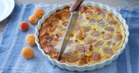 Cutting a slice of apricot clafoutis Stock-Footage 136040277