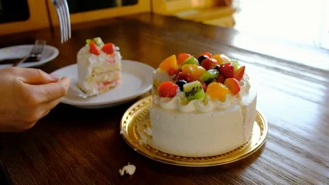 Cutting a slice of birthday cake Stock Footage 81542067