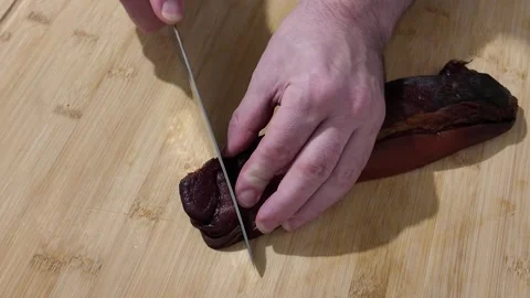 Cutting a Slice of Black Forest Cured Ham Stock-Footage 348108661