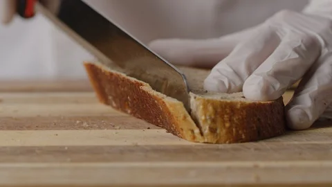 Cutting slice of brown bread on croutons macro shot Stock Footage 128485762