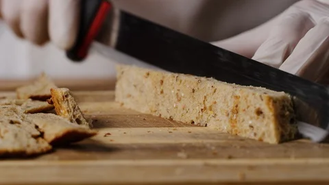 Cutting slice of brown bread on croutons macro shot Stock Footage 128486201