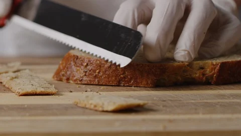 Cutting slice of brown bread on croutons macro shot Stock Footage 128486211