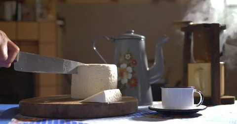 Cutting a slice of cheese at the farmhouse Stock Footage 82336467