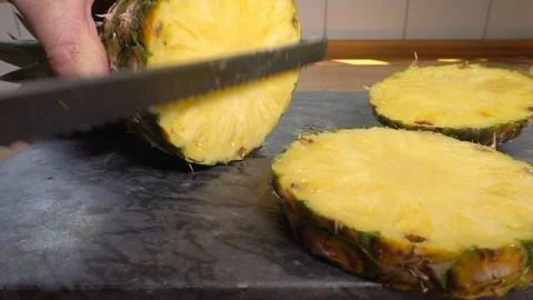Cutting a slice of fresh pineapple. Stock-Footage 113805576