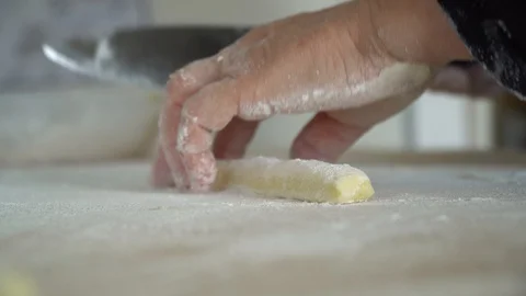 Cutting slice method of pasta gnocchi extreme close up Stock Footage 128987919