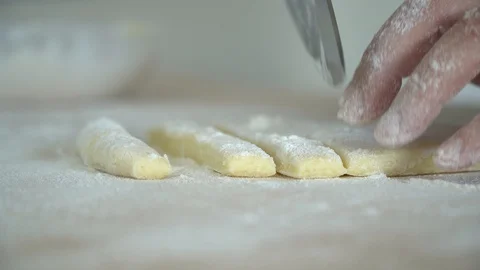 Cutting slice of pasta gnocchi extreme close up Stock Footage 128987976