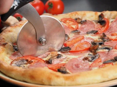 Cutting slice of pizza close up Stock Photos