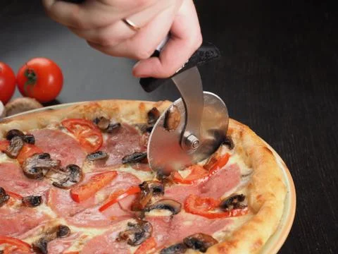 Cutting slice of pizza close up Stock Photos