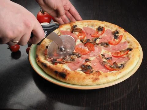 Cutting slice of pizza close up Stock Photos