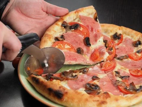 Cutting slice of pizza close up Stock Photos