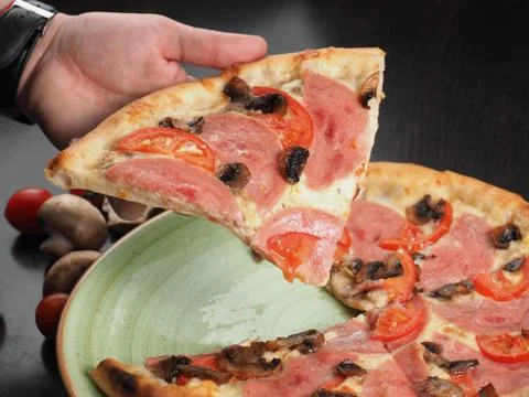 Cutting slice of pizza close up Stock Photos