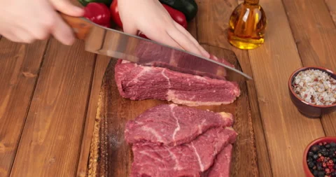 Cutting a slice of raw beef meat Stock Footage 170526649