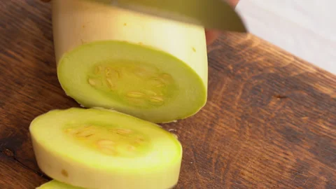 Cutting slices of the fresh light yellow vegetable marrow Stock Footage 248442058
