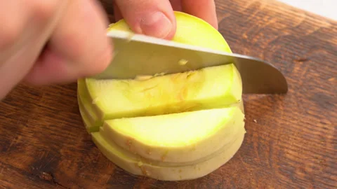 Cutting slices of the fresh light yellow vegetable marrow Stock Footage 248442389