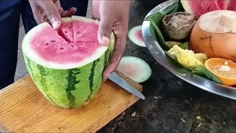 Cutting Slices of Red Watermelon for Sri Lankan Deity Offering Stock Footage 339059203