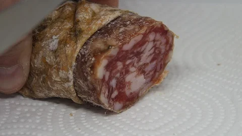 Cutting slices of Salami close-up Stock Footage 128318143