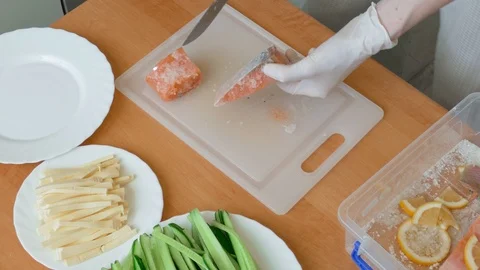 Cutting slices of salmon for sushi Stock Footage 104883641