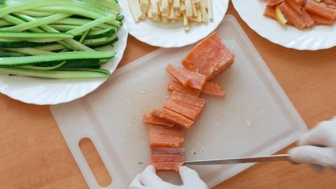 Cutting slices of salmon for sushi Stock Footage 104883907