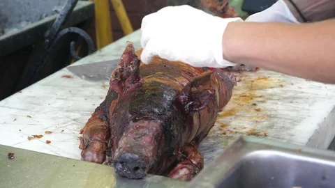 Cutting slicing just roasted on spit pig meat on street food festival in Sofia Stock Footage