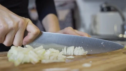 Cutting up, slicing an onion in to tiny pieces, preparing a diet to loose 動画素材 123152166