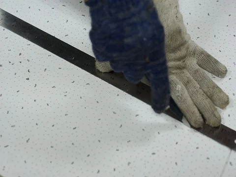 Cutting off a soft board using a knife and a steel ruler. Stock Footage 93825761