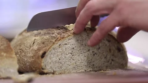 Cutting sourdough bread in a cutting board 스톡 동영상 133205677