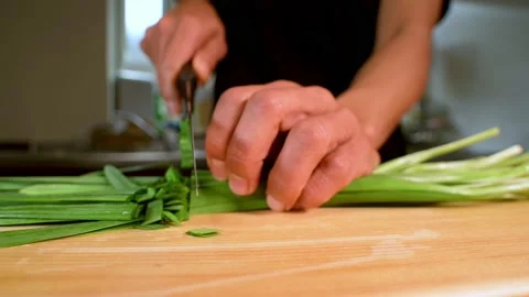Cutting spring onions in slowmotion close up. Stock Footage 234573986