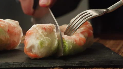 Cutting spring roll with shrimps and vegetables inside close-up macro. Shrimp Stock Footage 257509712