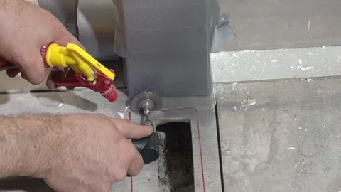 Cutting a square opening in ceramic tile with a small angle grinder and water Stock Footage 340644792