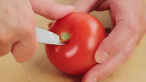 Cutting the stalk and core out of tomatoes Stock Footage 24667427