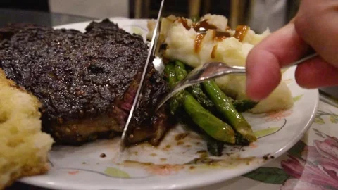 Cutting a steak with a knife 動画素材 268139379