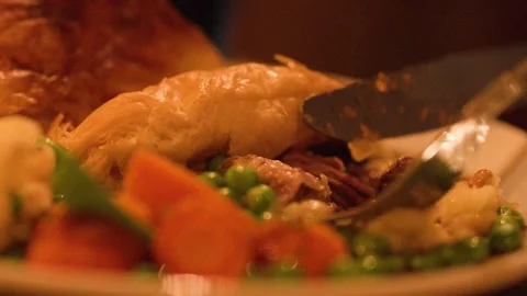Cutting Into Steak Pie with Vegetables in Cozy Restaurant Setting Stock Footage 317533636
