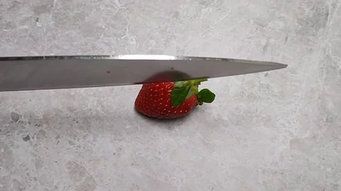 Cutting strawberries in half Stock Footage 167934071