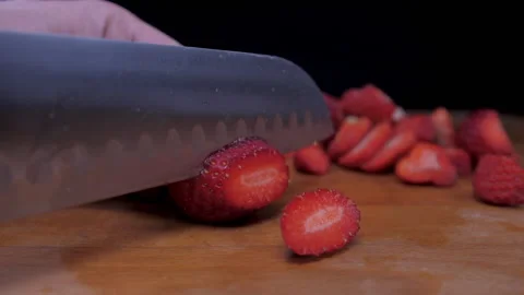 Cutting strawberry fruit with knife  Stock Footage 149705379
