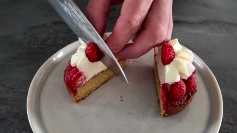 Cutting strawberry tartlet into quarters Stock Footage 345340441